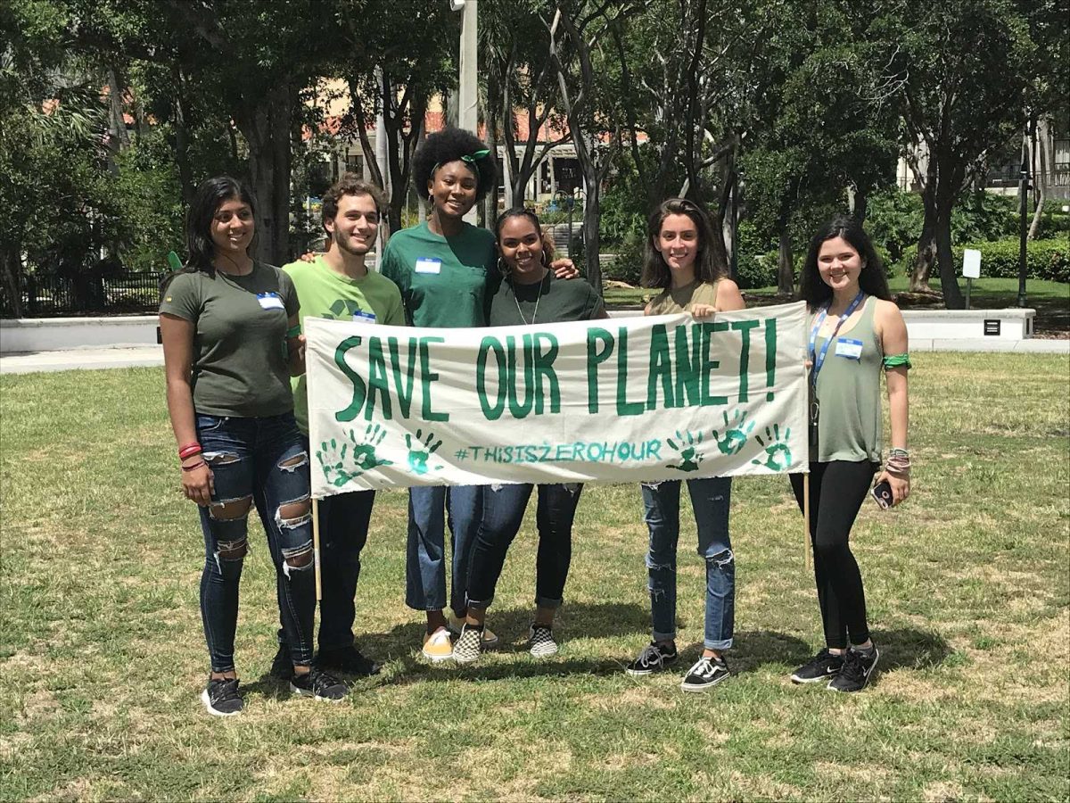 The organizers pose for a photo before the march. Green became the uniting color at the march. (Photo/Bella Ramirez)