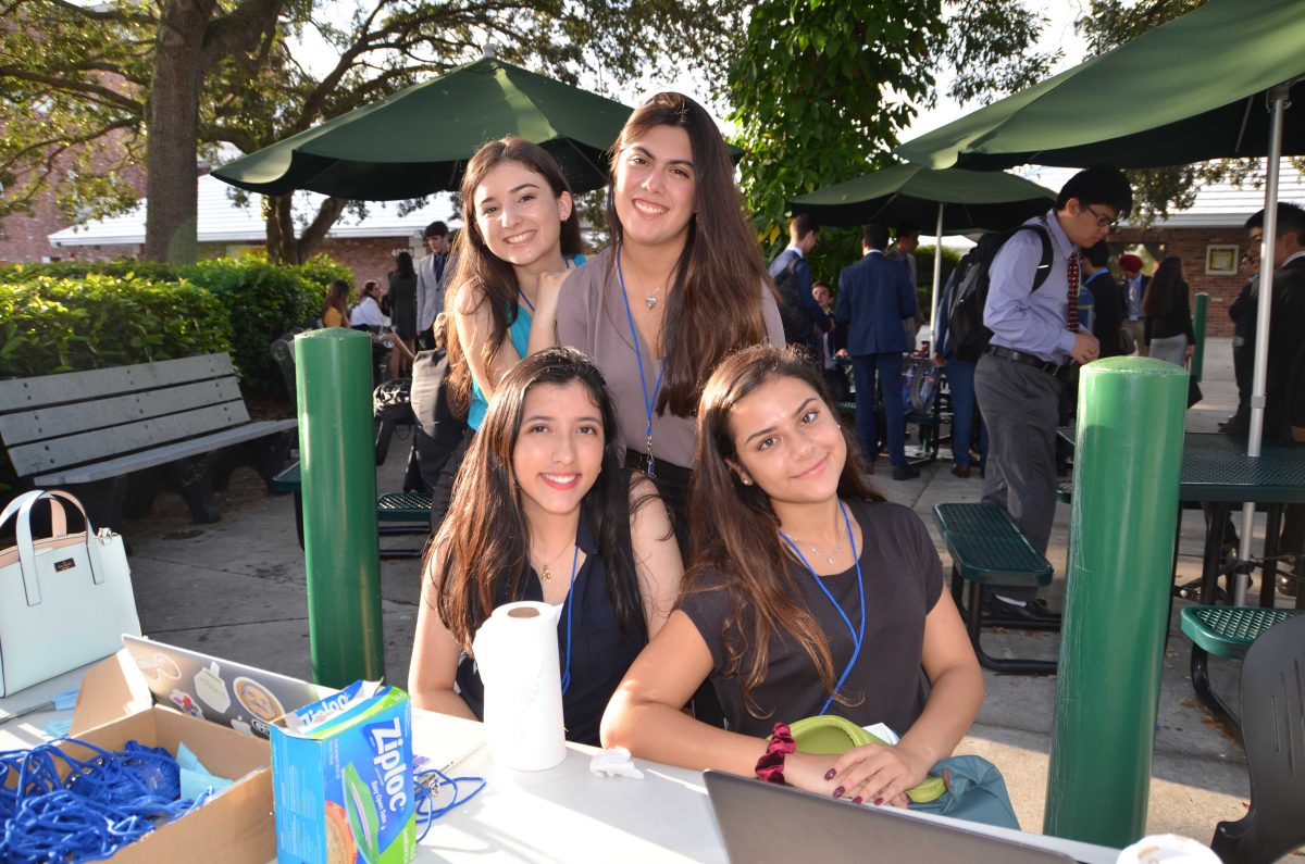 Seniors Daniela Valez (top left), Sofia Godoy (top right), Claudia Bermudez (bottom left) and Laila Inan (bottom right) prepare for AHPMUN registration early Saturday morning. (Photos/AHS Model UN)