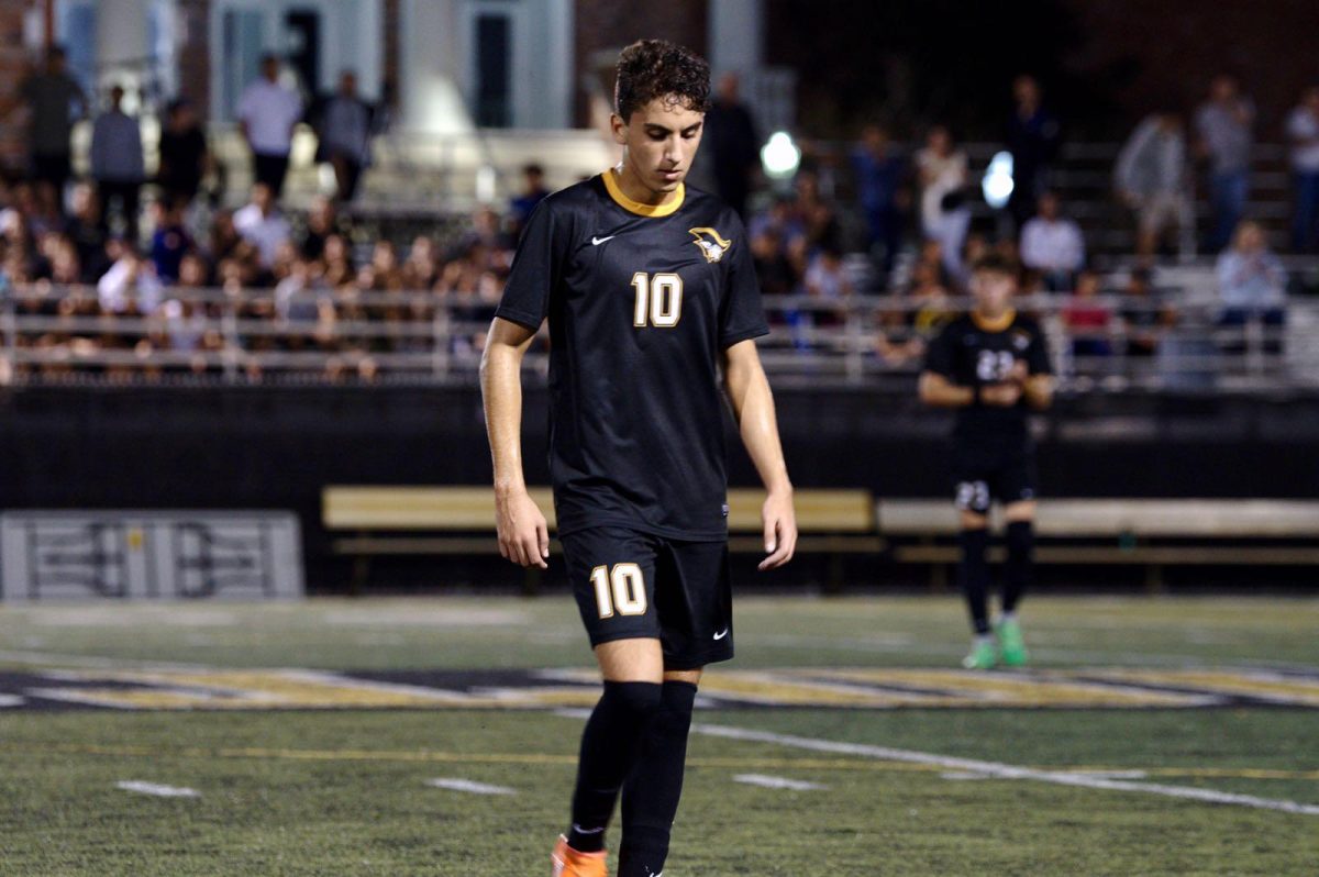 Senior Benjamin Grossi walks off the field in contemplation amidst the tense game against Cypress Bay High School. (Photo/Sara Soterakis)