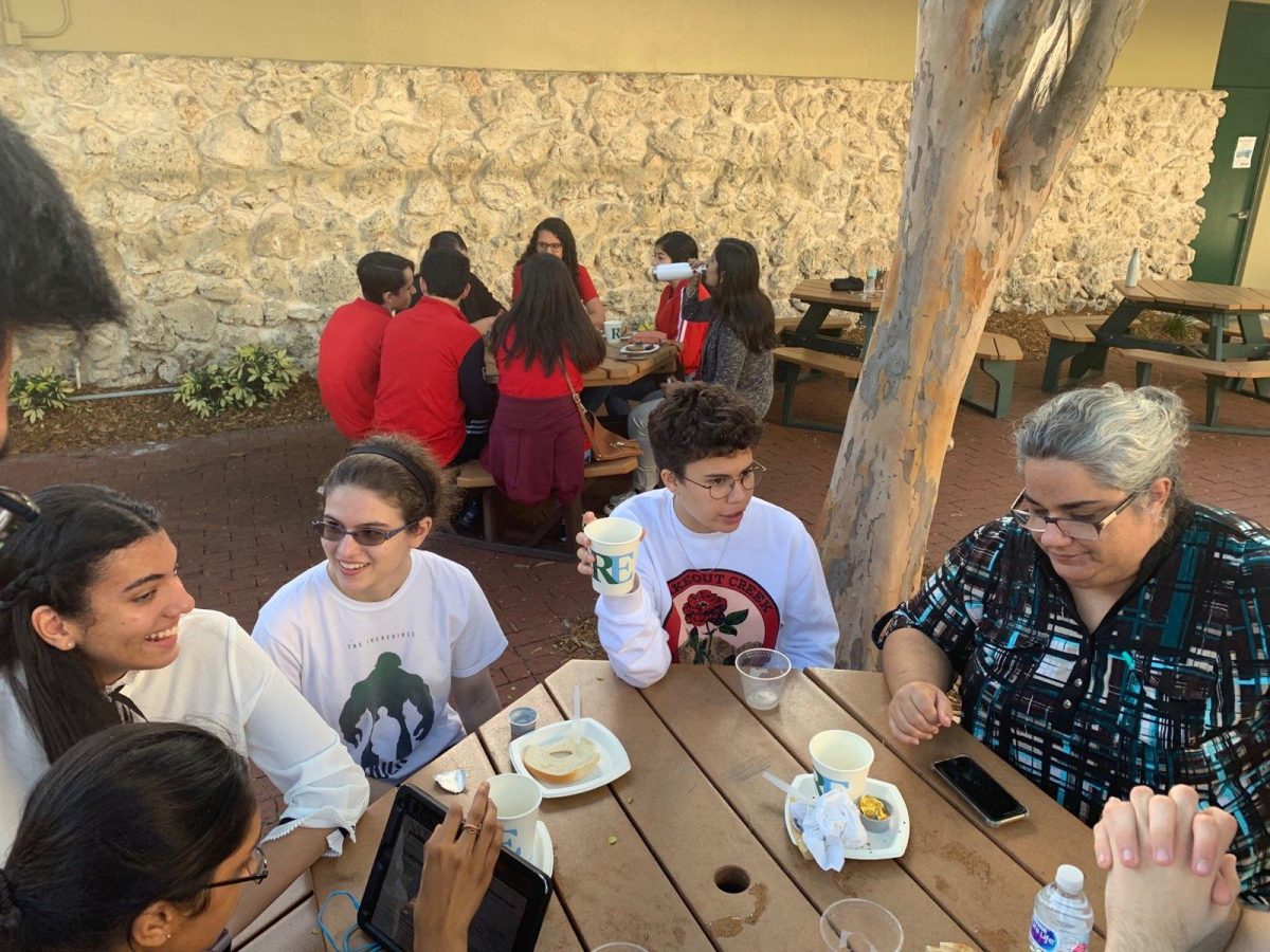 Senior Trishala Kumar, junior Annabella Lugo and seniors Emily Namm and Isabel Chameberlain discuss possible upcoming problems while Mrs. Cicos sits next to them. (Photo/Olivia Lloyd)