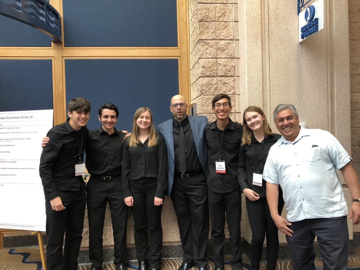 From left to right, all-State student guitarists junior Grant Sizemore, sophomore Ion Laor, senior Sarah Ham, junior Jacob Kasner and guitar teacher Mr. Jose Bronca snap a quick photo with conductor Mr. Chuck Hulihan (center), director of Glendale Community College Guitar Program and teacher for Guitar Foundation of America, after their first rehearsal. (Photo submitted by Jacob Kasner)